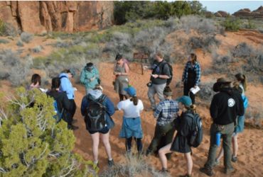 University of Akron geoscience students conduct fieldwork in a desert landscape during a group research excursion.